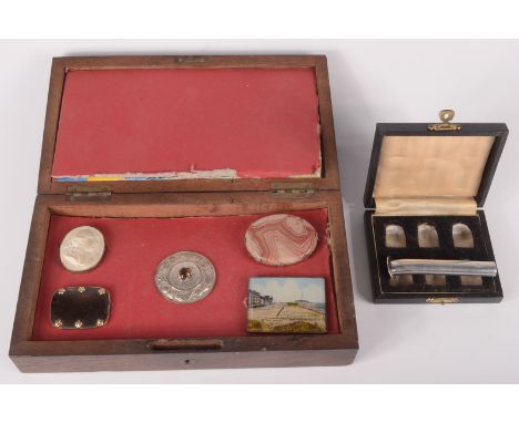 A box for six thimbles, together with a silver button hole insert and a box containing brooches etc. 