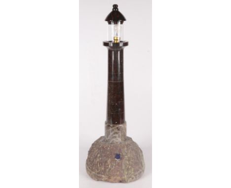 A serpentine table lamp, modelled as a lighthouse, height 53.5cm, diameter of base 19cm.