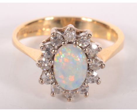 An 18ct gold diamond and opal ring.