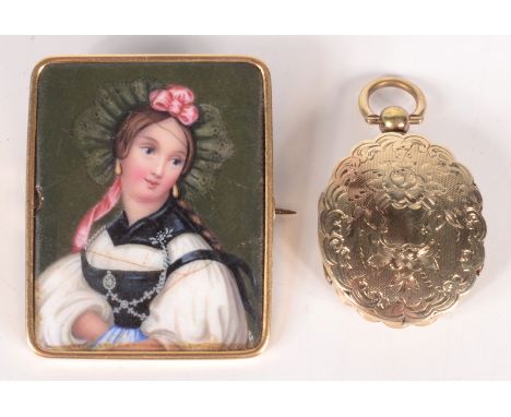 A Victorian engraved gold mounted oval locket with hinged cover to the front and back, together with a gold brooch set with a