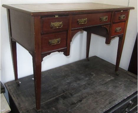 An Edwardian mahogany writing desk, with a tan leather rectangular inset top above an arrangement of five drawers on square, 