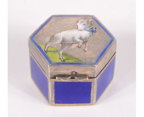 An Austro-Hungarian hexagonal small silver pill box, the lid with a cavorting goat, the sides dark blue enamel, width 20mm. C