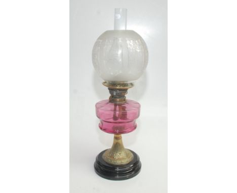 A brass and cranberry glass oil lamp, early 20th century, height 58.5cm. Condition report: No obvious damage.