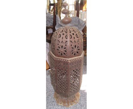 A large metal Moroccan lantern with pierced body and single hinged door, height 100cm, width 29cm. 