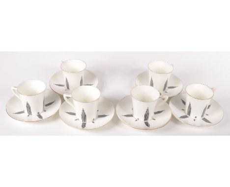 A set of six Art Deco porcelain cups and saucers, black painted initials JTH, cups height 6.4cm, saucers diameter 13.1cm.