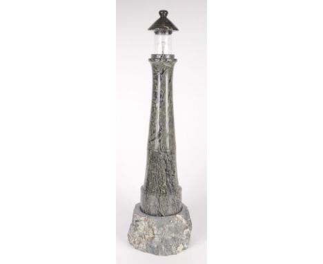 A serpentine table lamp, modelled as a lighthouse, height 57.5cm, diameter of base 16.5cm.