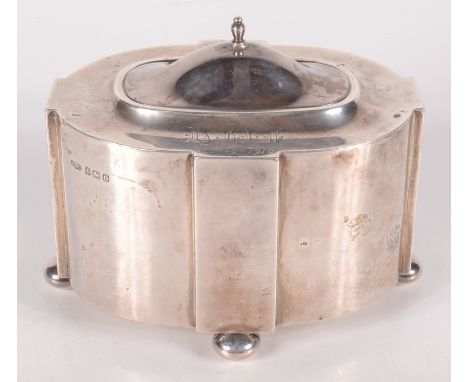 A cruciform silver tea caddy on bun feet, Birmingham 1913, 6.8oz.  Condition report: Condition is warn, multiple little dents