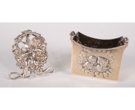 A William Hutton silver menu holder cast with a cherub, Sheffield 1898, together with a silver prayer book holder with emboss