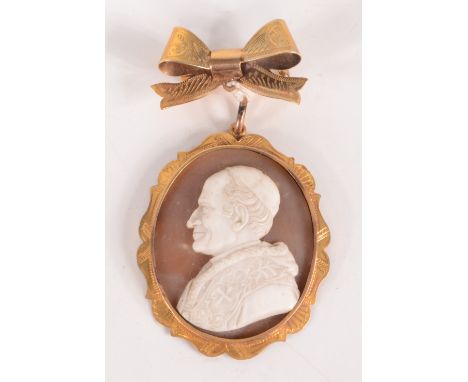 A 19th century Italian carved shell portrait of a pontiff in chased gold pendant mount, hanging from an English 9ct gold bow 