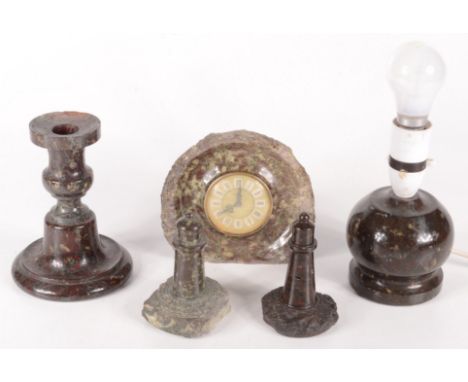 Miscellaneous Cornish serpentine, to include a candlestick, height 15cm, a lamp base, a mantel clock and two lighthouse model