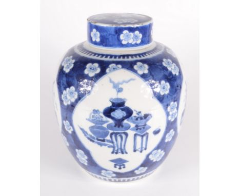 A Chinese blue and white porcelain prunus pattern ginger jar and cover, circa 1900, each of the four ivory ground cartouches 