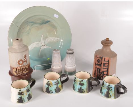 Four Celtic Pottery cups, height 7cm, two pepper pots, height 13cm, a Carnon Downs pottery plate, diameter 32.5cm and two Tre