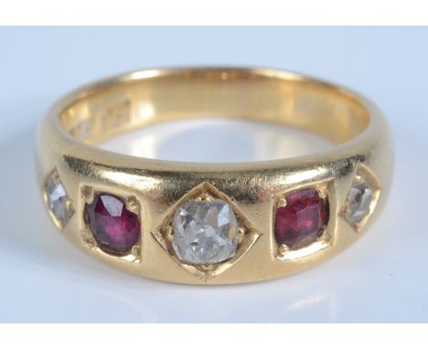 An 18ct gold ring gypsy set with three diamonds and two rubies, 8g. Condition report: Ring size - R 1/2 