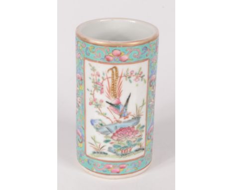 A Chinese famille rose porcelain brush pot, 19th century, the foliate decorated pale blue ground with two ivory panels with b