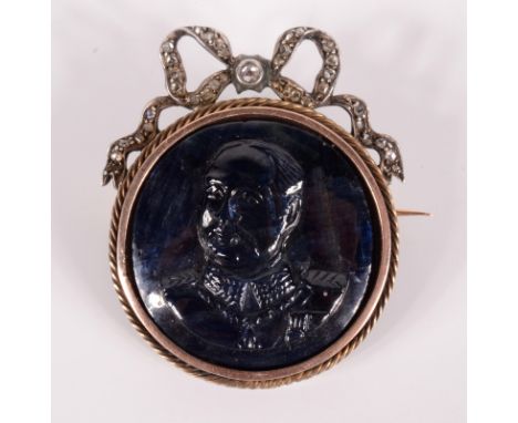 A sapphire cameo brooch, the military portrait beneath a diamond set ribbon.    Condition report:  35mm high, diameter 27.7mm