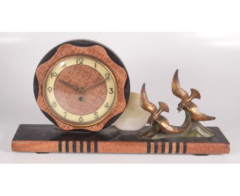 An Art Deco black slate and marble mantle clock, with a 14.5cm dial and a pair of gilt metal birds in flight, height 24.5cm, 