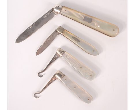 Two fruit knives with folding silver blades and two folding silver button hooks.