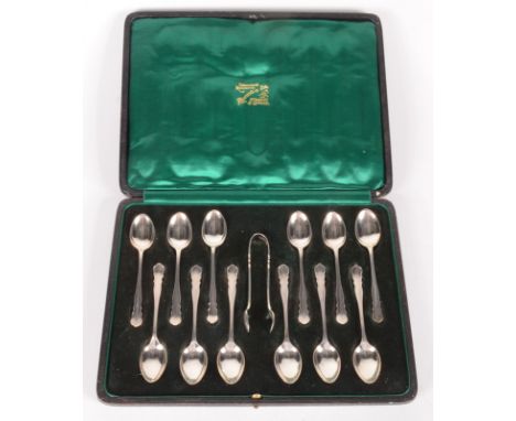 A set of twelve William Hutton silver coffee spoons and tongs Sheffield 1919, retailed by Russells, Liverpool, cased. 