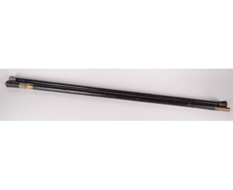 A sword stick, in the form of a walking cane, length 90.5cm and a silver topped walking cane, length 89cm.