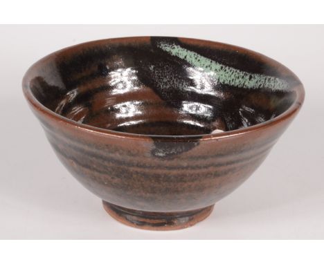 A Trevor Corser Leach pottery footed bowl, the tenmoku glaze with abstract decoration to the interior, impressed personal and