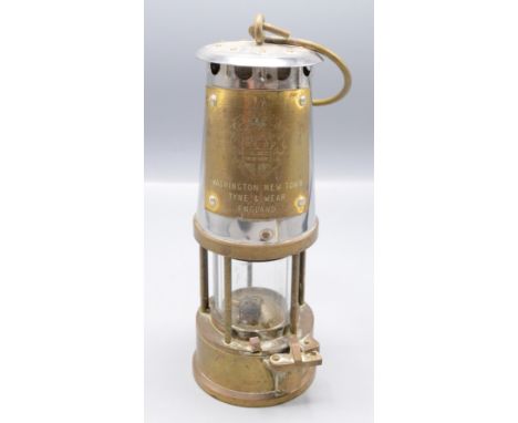 A Protector miners safety lamp, inscribed 'Washington New Town, Tyne & Wear, England', height 24cm.