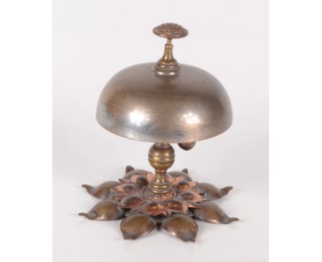 An Arts and Crafts copper and brass desk bell, height 11.5cm.  Condition report: In good order and functional.