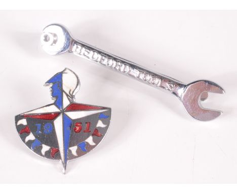 A 1951 Festival of Britain souvenir enamelled brooch and a Bedford Tools advertising tie clip in the shape of a spanner. 