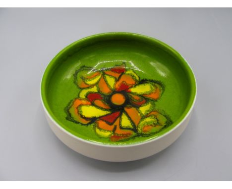 A Poole Pottery footed bowl, the green ground with a central abstract design, number 88 and black painted signature to the ba