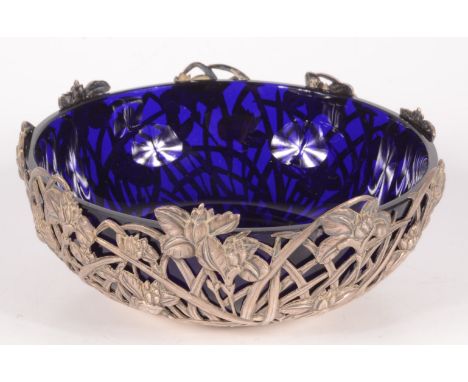 A Chinese pierced silver bowl, marked 90 WH for Wang Hing, decorated with irises, with a blue glass liner, height 5.2cm, diam
