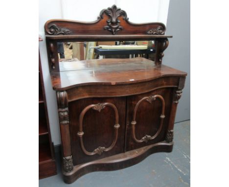 A Victorian rosewood serpentine chiffonier, the rectangular mirror back and shelf above a single long frieze drawer above a p