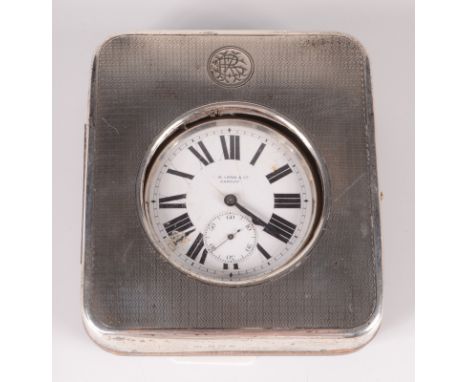 A nickel eight day travelling timepiece in engine turned silver mounted case. 