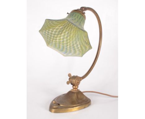 An Art Nouveau adjustable brass desk lamp, with a green and blue mottled flared glass shade, height 37cm, depth 34cm, width o