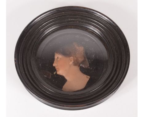 A Victorian wax silhouette portrait of a lady, in a circular ebonised frame, diameter 17cm.  Condition report: The wax portra