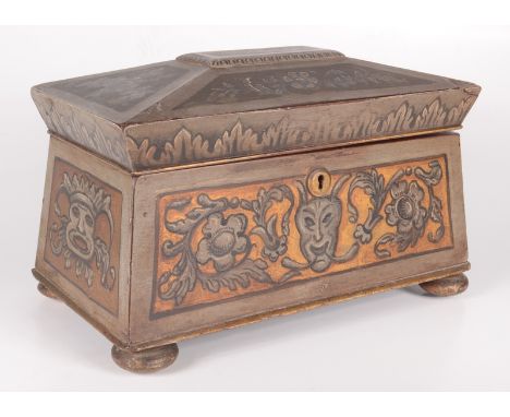 A mahogany painted tea caddy, 19th century, of sarcophagus form, decorated with grotesque masks and foliage, on bun feet, hei