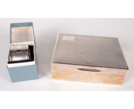 An engine turned silver cigarette case, together with an engine turned silver napkin ring. 