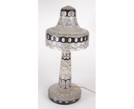 A cut glass enamel table lamp and shade, early 20th century, painted with roses and ribbons, height 53cm, diameter 23cm.  Con