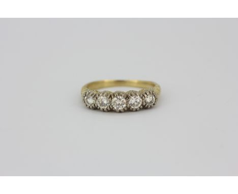 A yellow metal (tested 18ct gold) ring set with five brilliant cut diamonds, approx. 1ct overall, (O.5).