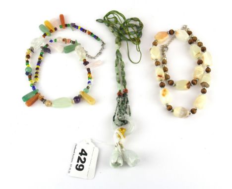 A necklace of mixed coloured jade beads, together with two further semi-precious stone necklaces.