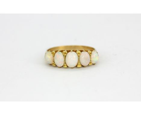 A yellow metal (tested 18ct gold) opal set ring, (M).