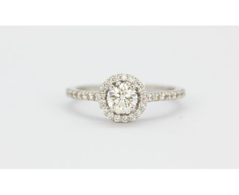 An 18ct white gold (stamped 750) halo ring set with a brilliant cut diamond surrounded by diamonds, approx. 1ct overall, (O.5