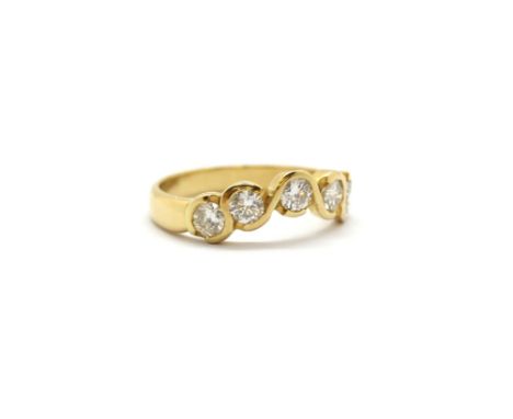 An 18ct yellow gold ring set with five brilliant cut diamonds, (P.5).