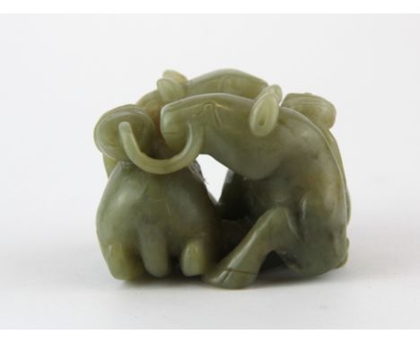 A fine Chinese carved olive green nephrite Jade model of two horses with strings of cash, 6 x 4.5 x 4.5cm.