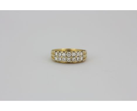 An 18ct yellow gold (stamped 750) ring set with two rows of brilliant cut diamonds, (L).