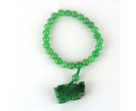 A polished jade bead bracelet.