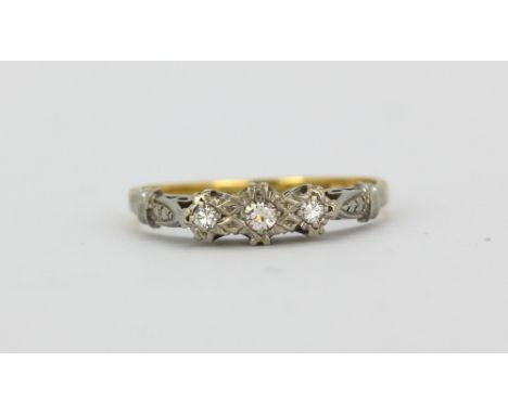 An 18ct yellow gold and platinum ring set with three brilliant cut diamonds, (N.5).