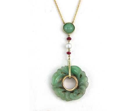 An 18ct yellow gold (stamped 750) necklace set with a carved jade amulet, rubies and pearls, L. 5.5cm.