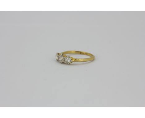 An 18ct yellow gold and platinum ring set with three brilliant cut diamonds, approx. 0.80ct overall, (N).