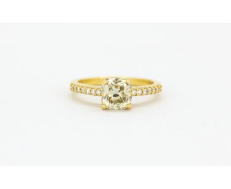 An 18ct yellow gold ring set with a cushion cut fancy light yellow diamond and brilliant cut diamond set shoulders, approx. 1