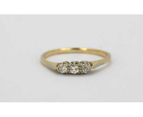 A yellow metal (tested high carat gold) ring set with three brilliant cut diamonds, (Q).