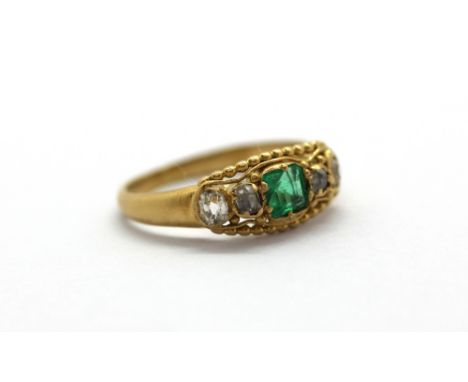 A yellow metal (tested 18ct gold) ring set with emerald and diamonds, (D.5).